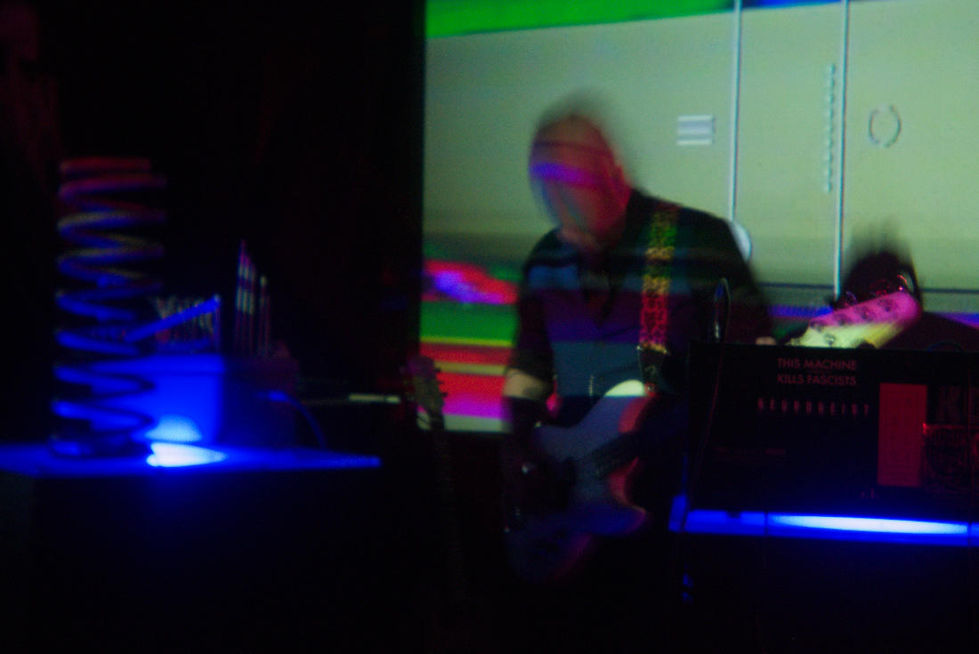 Guitarist lit by projections